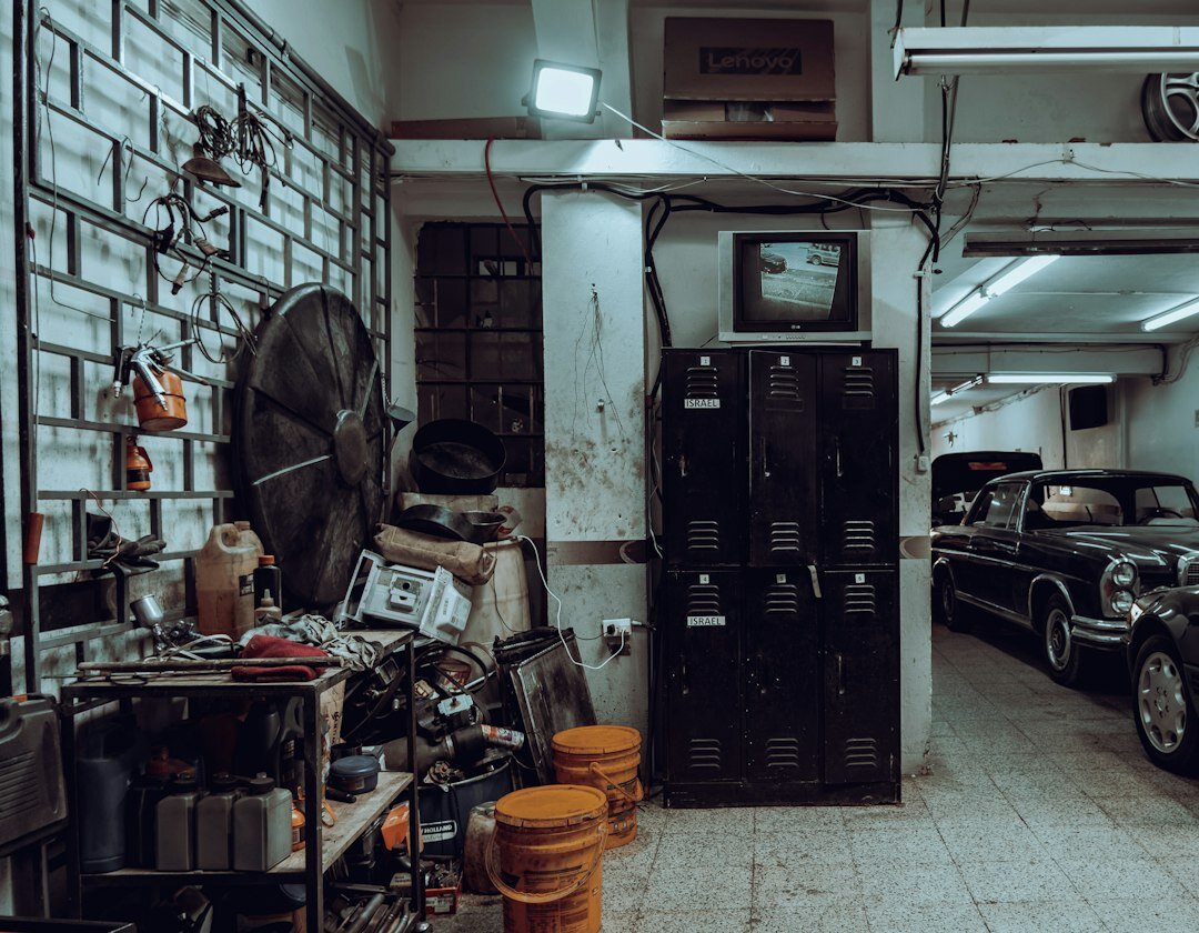 Old brick garage filled with vintage automobiles and tools