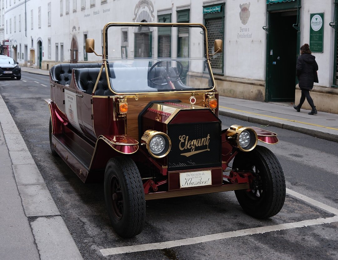 Elegant 1930s European automobile with long hood and spoked wheels