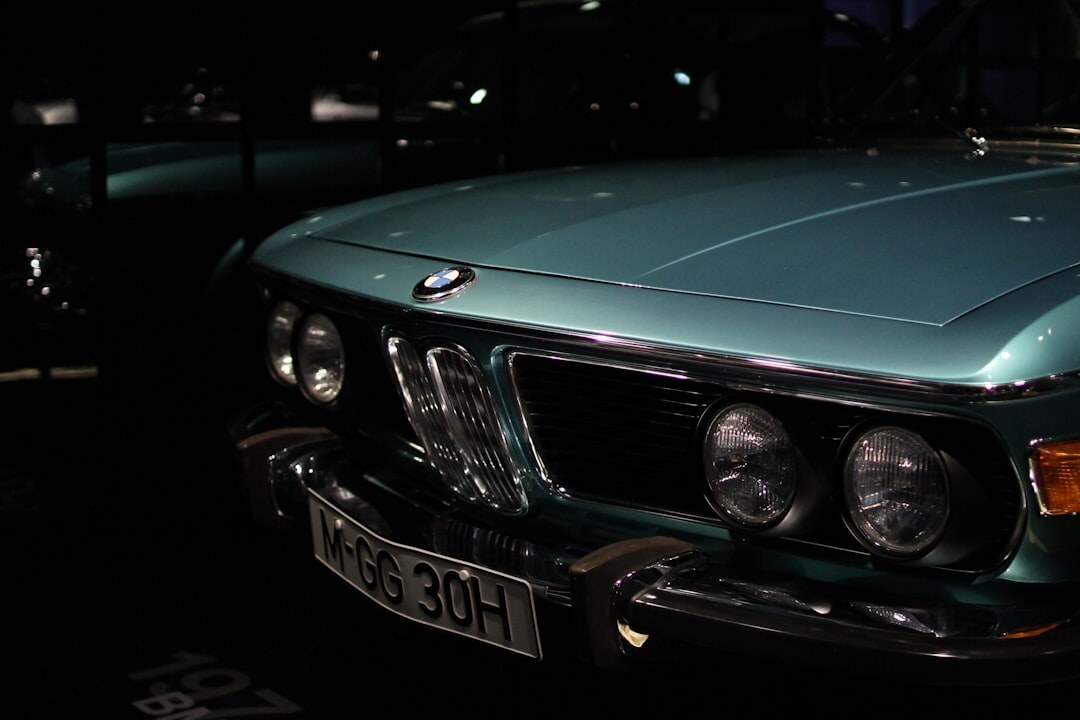 Private collection of classic automobiles under moody warm lighting