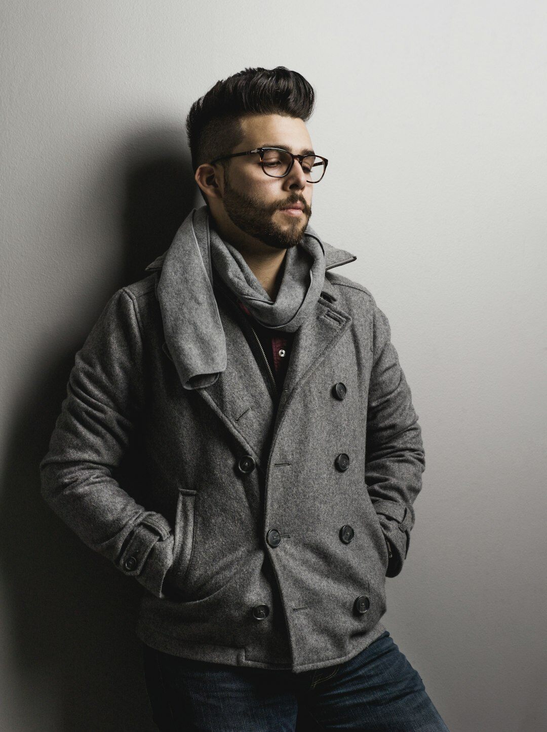 Studio portrait of a Hispanic man in his forties with a beard, smart casual jacket