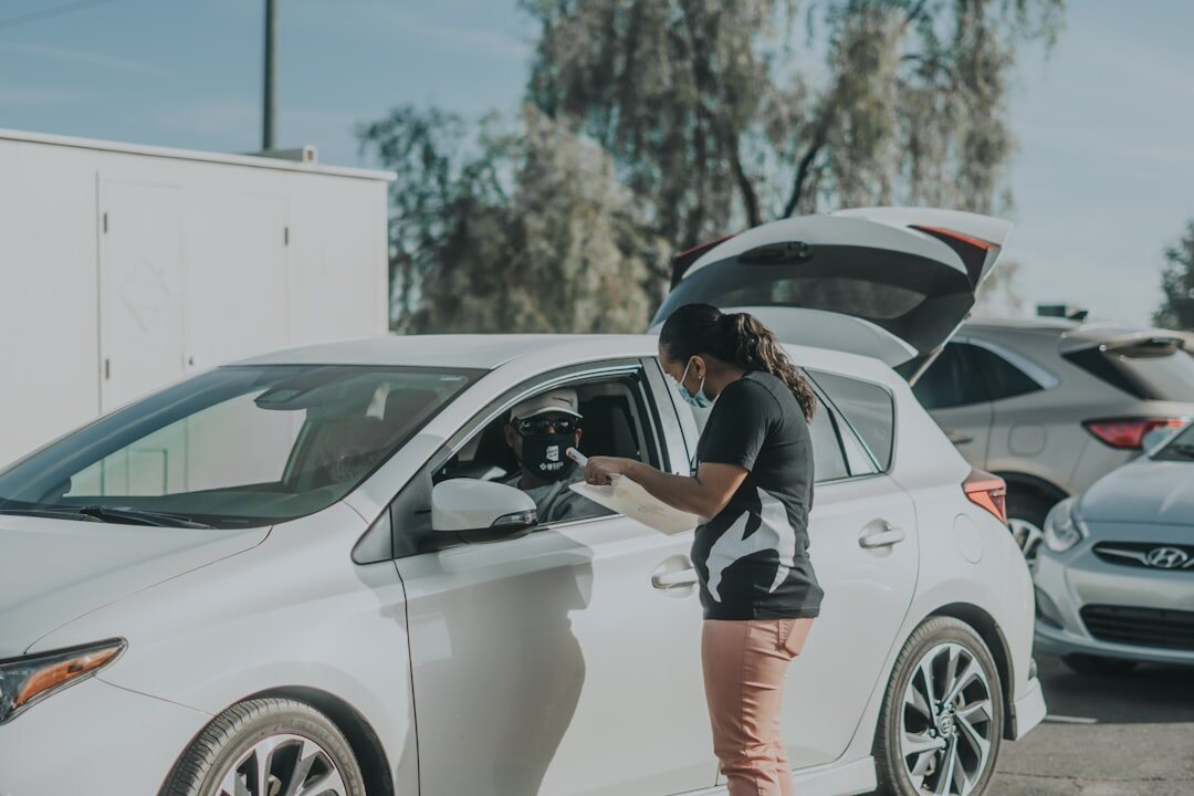person inspecting car